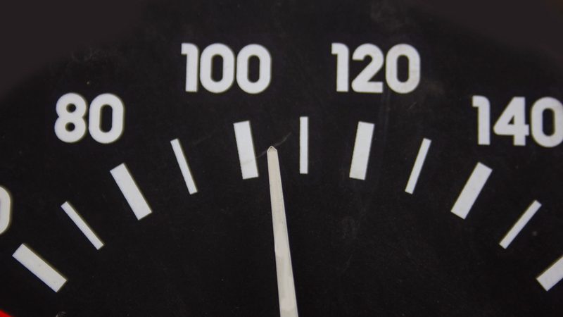 A speedometer dial reading past 100